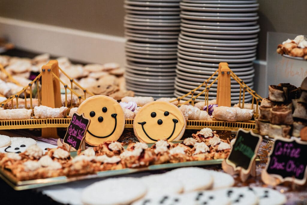 Smiling wedding cookie decorations displayed at a reception dessert table at The Fez