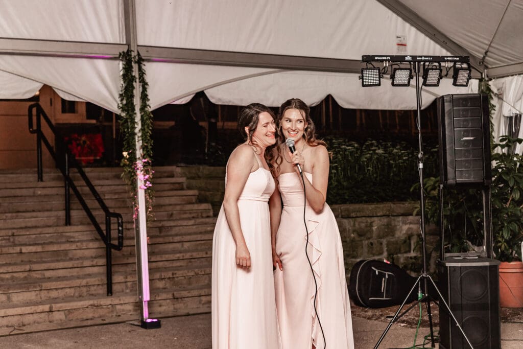 Bridesmaids singing a song for the bride and groom at a Phipps Botanical Gardens wedding reception