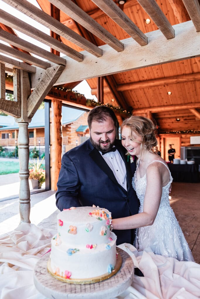 Bride and groom cutting their wedding cake at The Gathering Place at Darlington Lake reception
