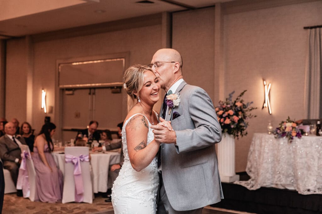 Bride and her dad share a hug during father daughter dance at Pittsburgh Airport Marriott