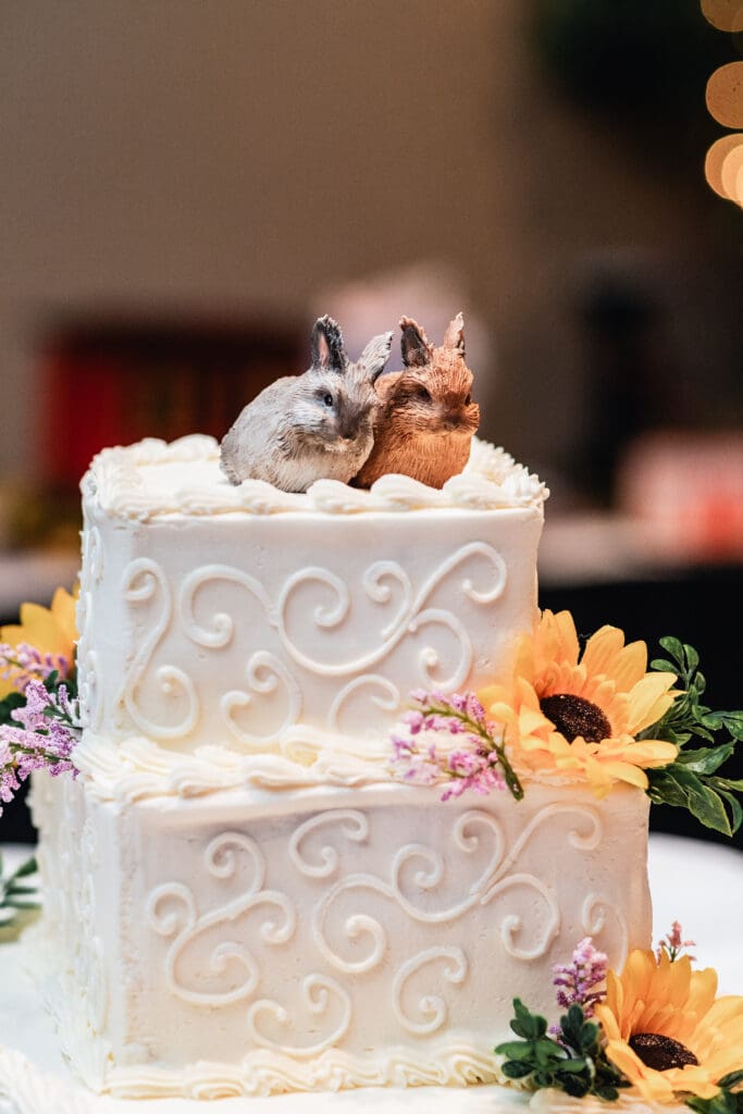 Two-tiered white wedding cake with sunflowers at The Fez