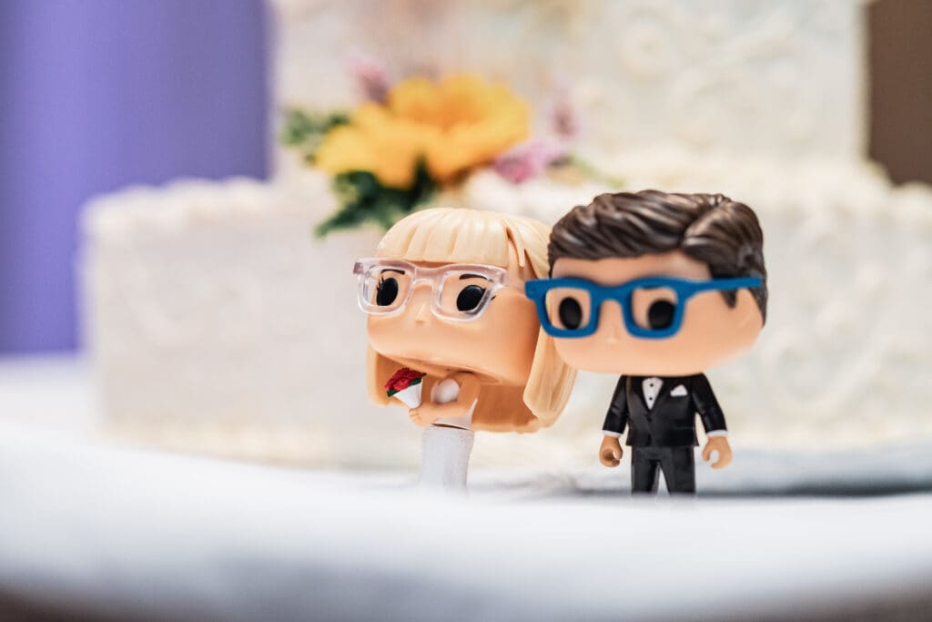 Cartoon-style bride and groom cake toppers at a wedding at The Fez