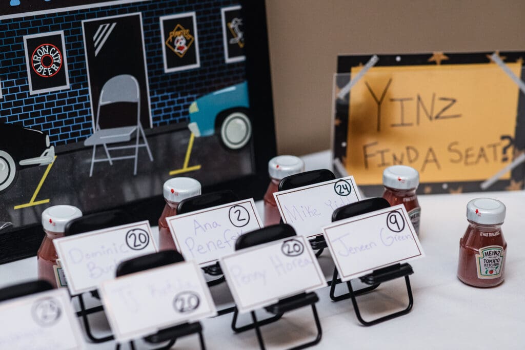 Small black folding chairs with white name cards arranged for a wedding at The Fez