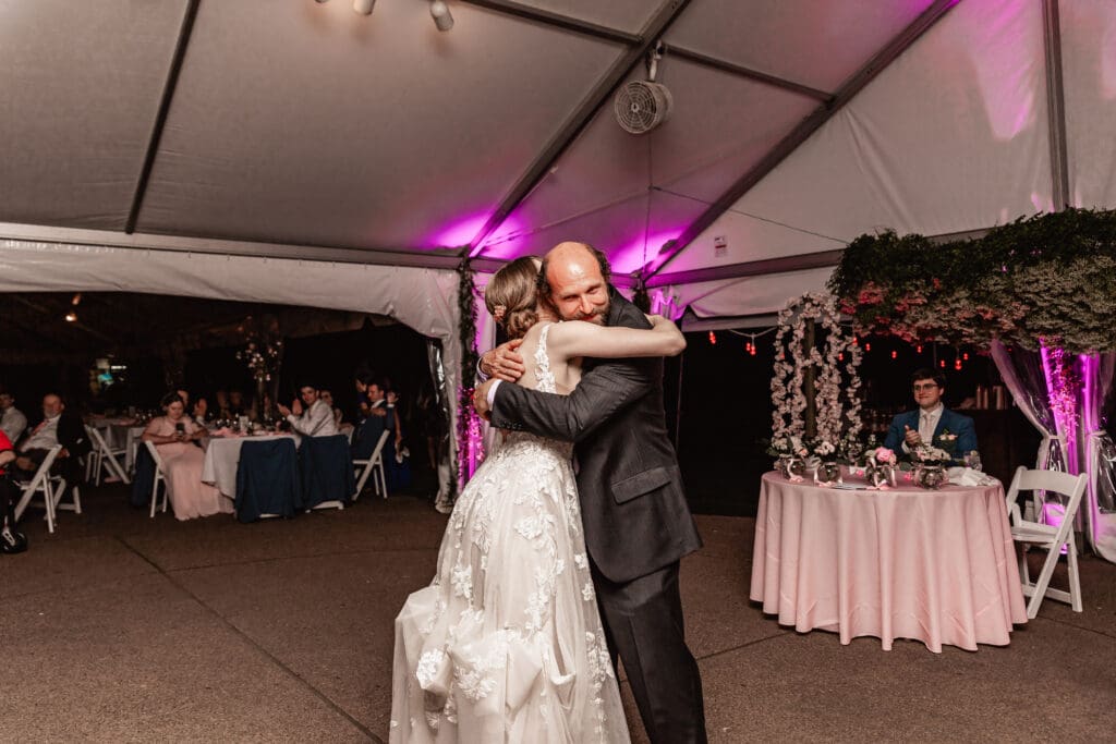 Bride hugging her father after their father-daughter dance at Phipps Botanical Gardens wedding reception