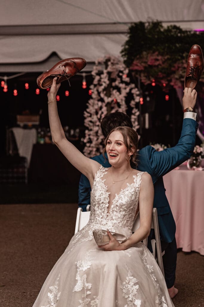 Pittsburgh bride laughing while playing the shoe game at her Phipps Botanical Gardens reception