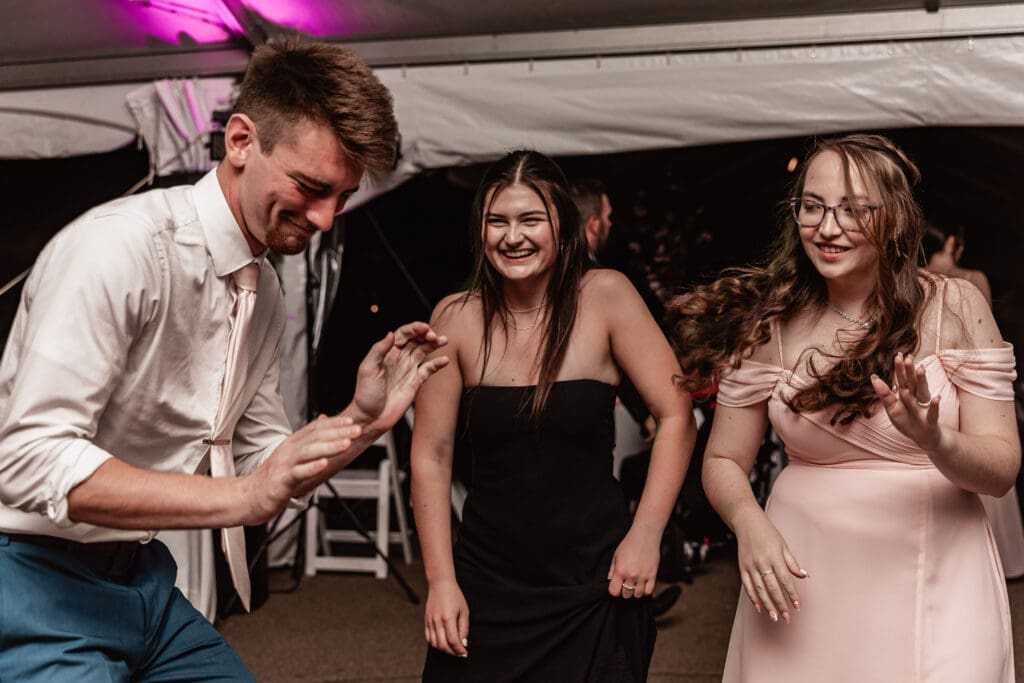 Wedding guests dancing and laughing during a Pittsburgh Phipps Botanical Gardens reception