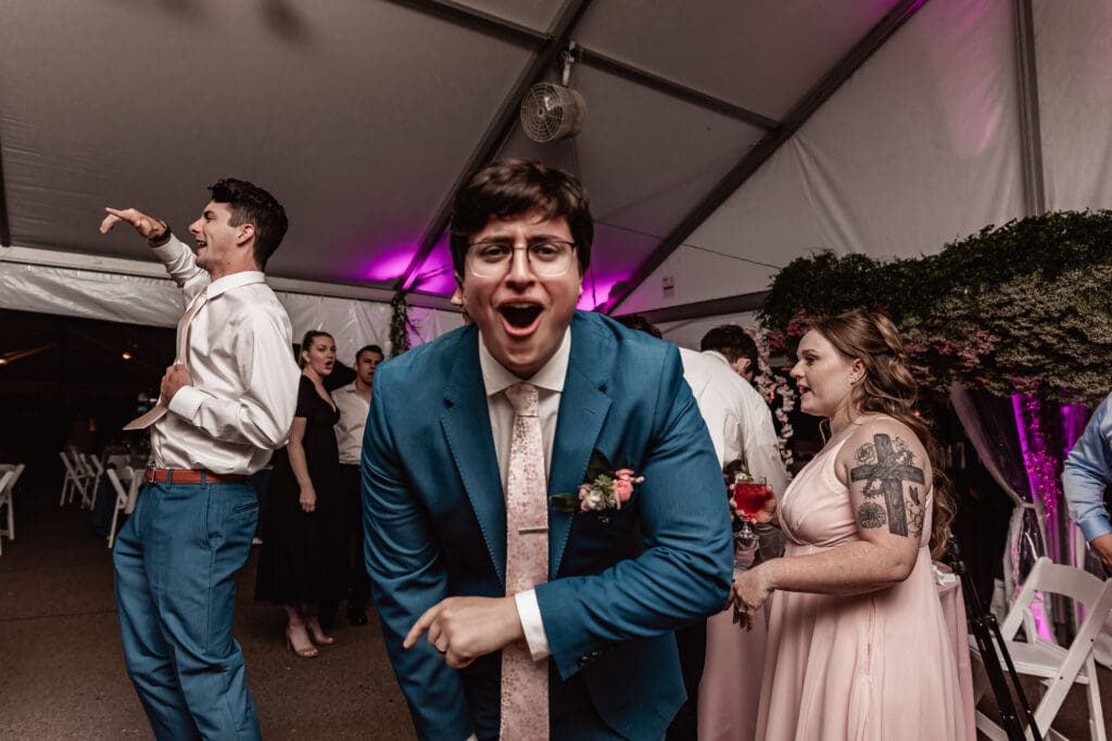 Pittsburgh groom dancing, cheering, and laughing with guests at Phipps Botanical Gardens reception
