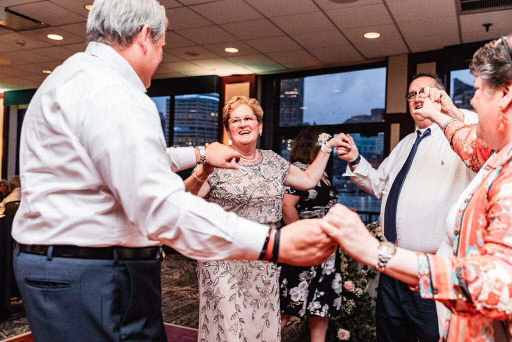 Wedding guests dance and celebrate together under warm lighting at Sheraton Station Square