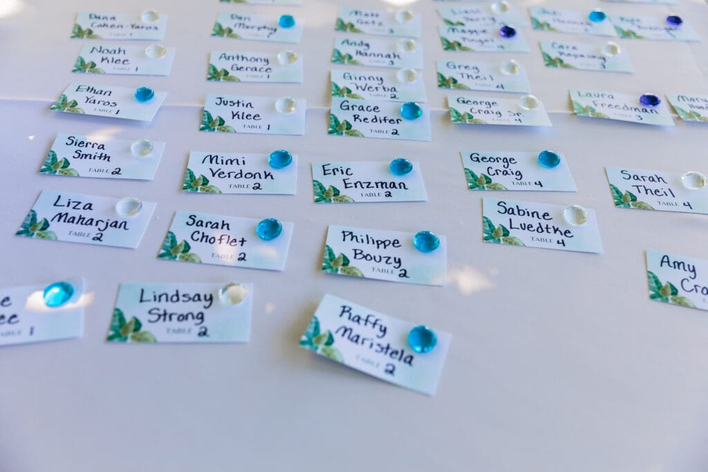 Close-up of wedding place cards displayed with glass pebbles at a Pittsburgh microwedding