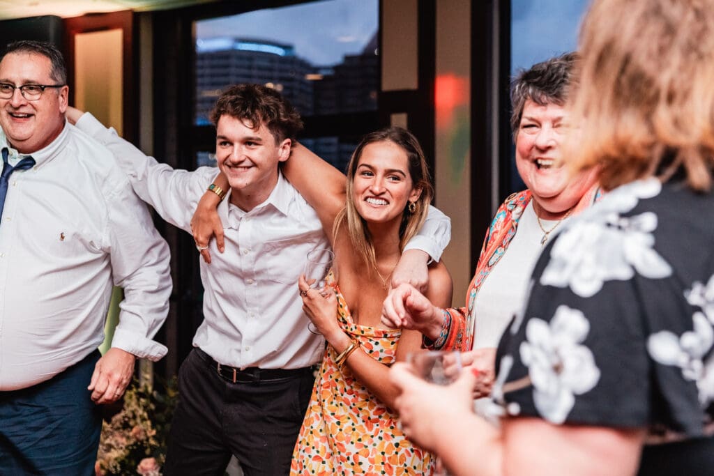 Party guests laugh and dance together on the dance floor during a Sheraton Station Square wedding