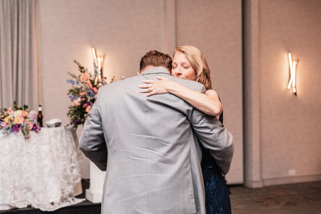 Groom and his mother share emotional embrace during reception dance at Pittsburgh Airport Marriott