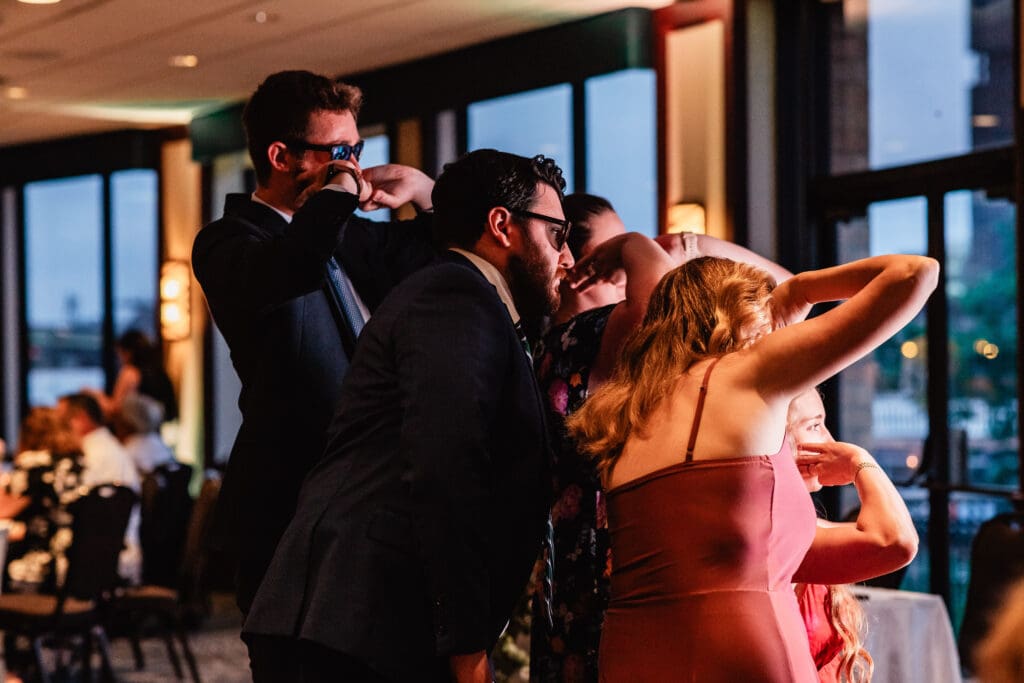 Wedding guests pose for photobooth at Sheraton Station Square reception