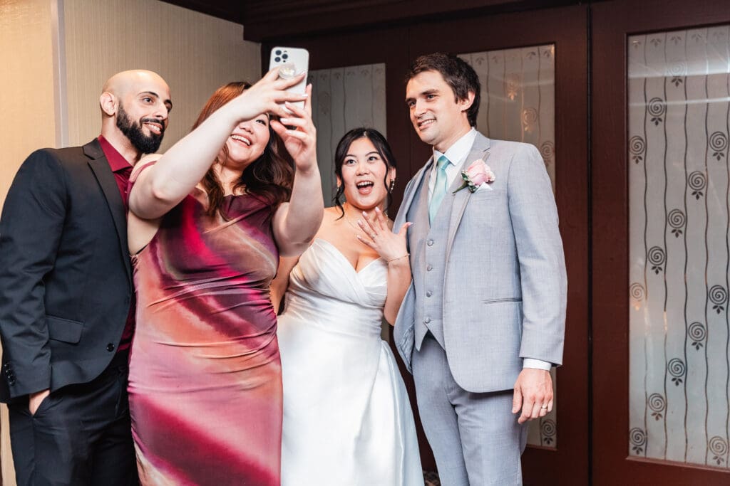 Wedding couple shares a candid moment with guests during their reception at Sheraton Station Square