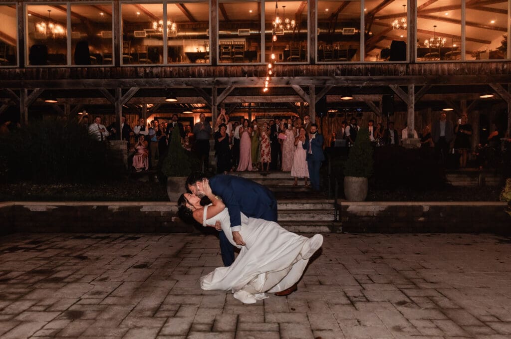 Bride and groom share a dip kiss following their first dance at a Willowbrook wedding reception in Volant, Pennsylvania