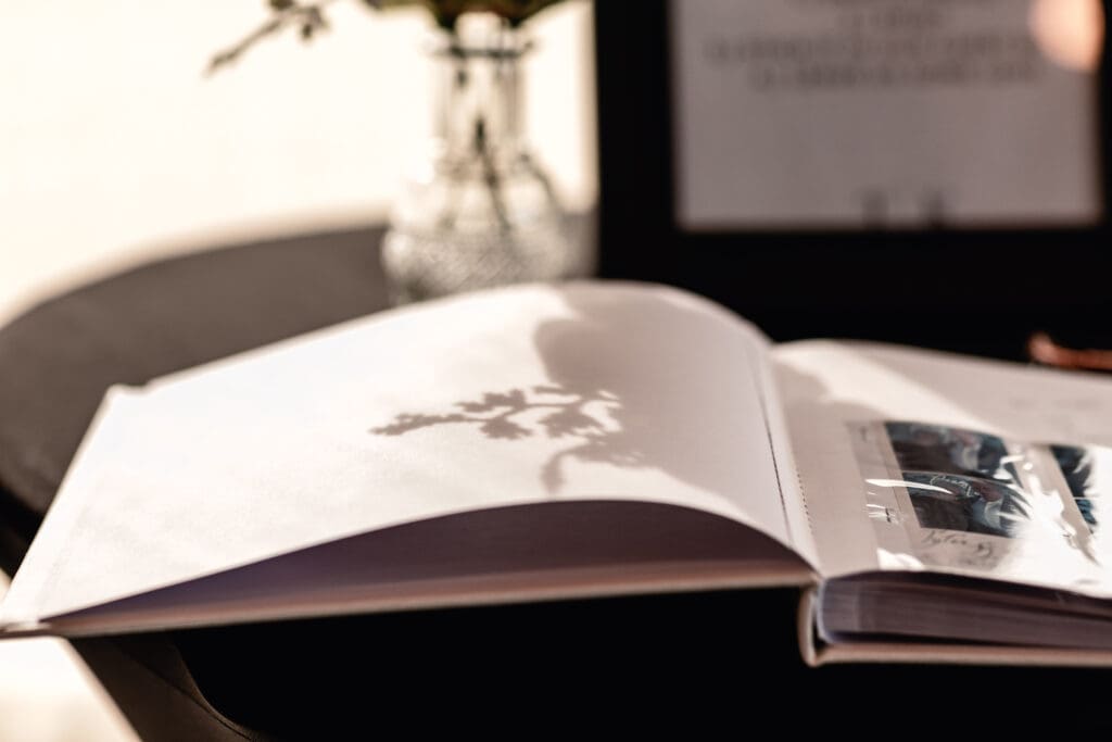 Soft floral shadows falling across a wedding guestbook at a Le Mont wedding reception in Pittsburgh