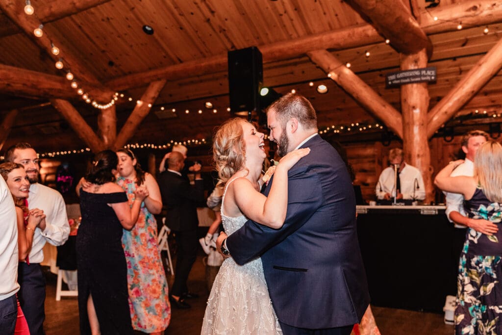 Bride and groom dancing and laughing at The Gathering Place at Darlington Lake wedding reception