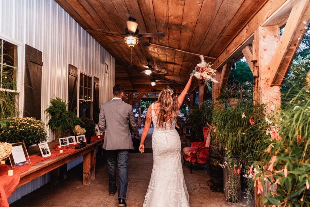 Wedding couple making their way to their rustic porch reception at Hinckston Run Farm