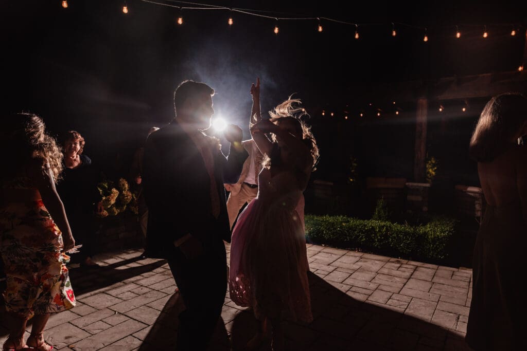 Silhouette of wedding guests dancing during an evening reception at Willowbrook in Volant, Pennsylvania