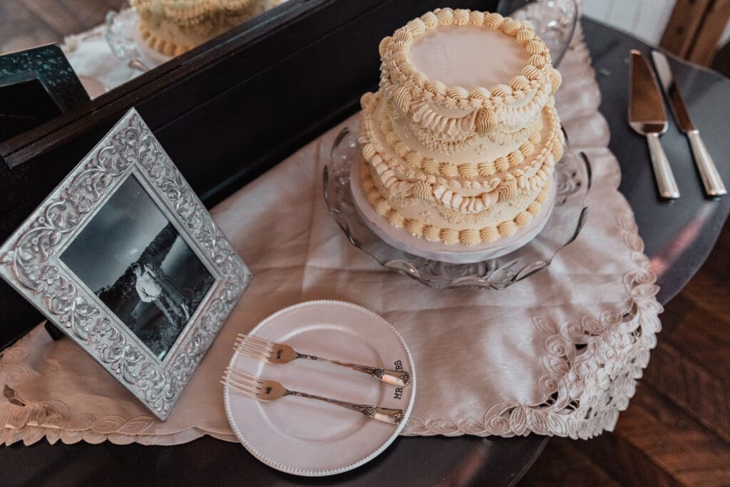 White tiered wedding cake with delicate piping displayed at a Willowbrook wedding