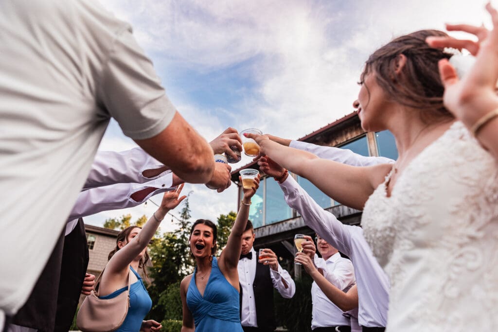 Wedding party celebrates together on the dance floor at an outdoor Willowbrook reception