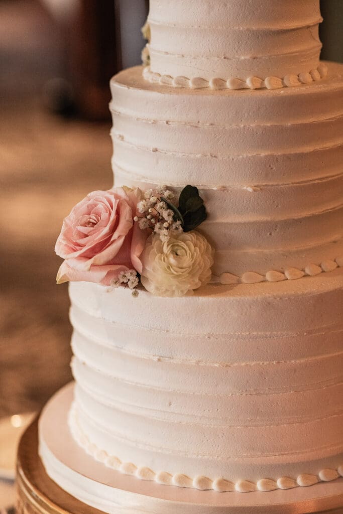 Close up of floral detailing on a white wedding cake at a Sheraton Station Square wedding