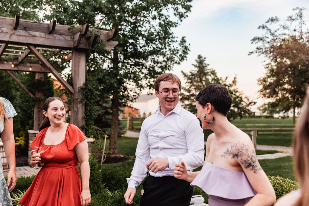 Couples dancing together during an outdoor Willowbrook wedding reception at golden hour