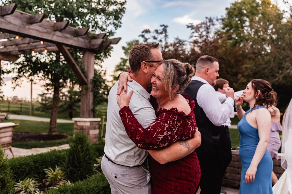 Couples dancing together during an outdoor Willowbrook wedding reception at golden hour