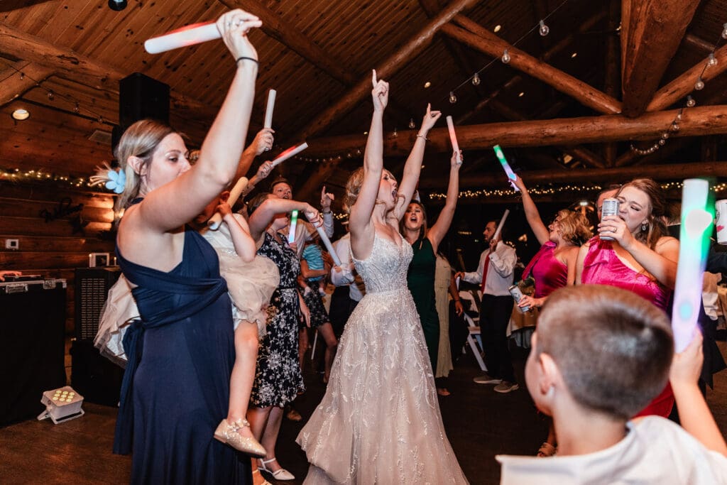 Bride and groom laughing and dancing with guests at The Gathering Place at Darlington Lake