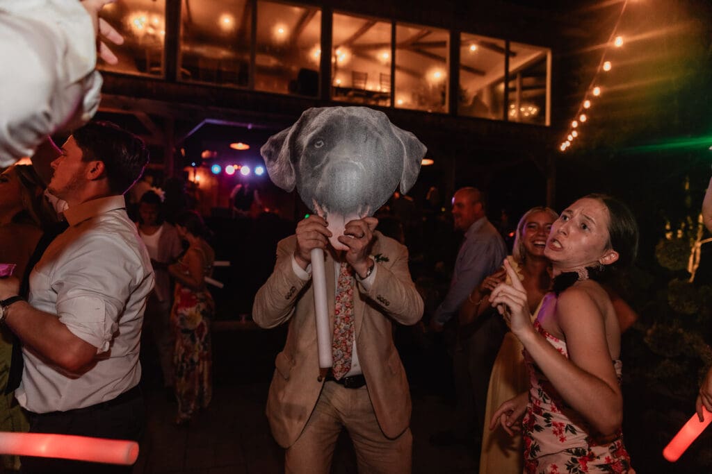 Father of the bride dances with a cardboard cutout of the couple’s dog during a joyful wedding reception at Willowbrook in Volant, Pennsylvania