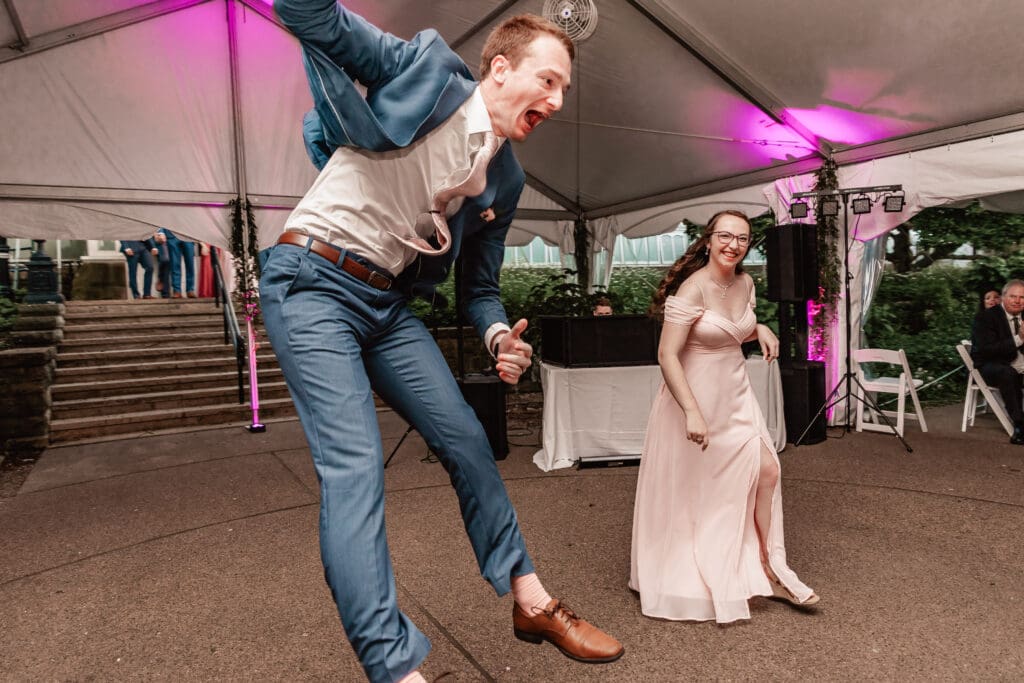 Bridesmaids and groomsmen celebrating during their reception entrance at Phipps Botanical Gardens in Pittsburgh