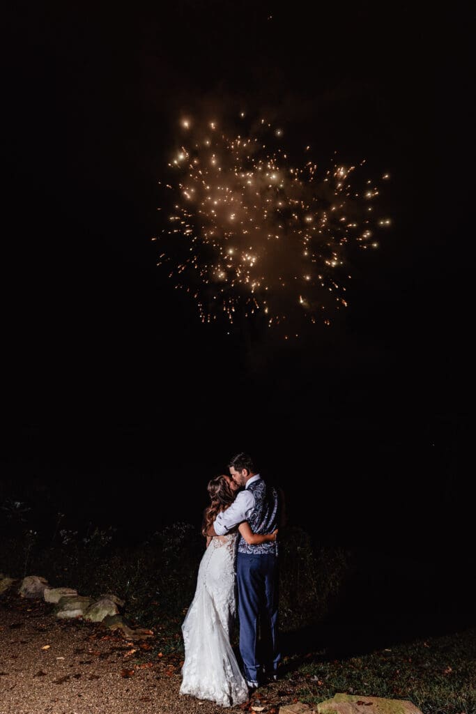 Newlyweds enjoy fireworks during their outdoor wedding celebration at Hinckston Run Farm