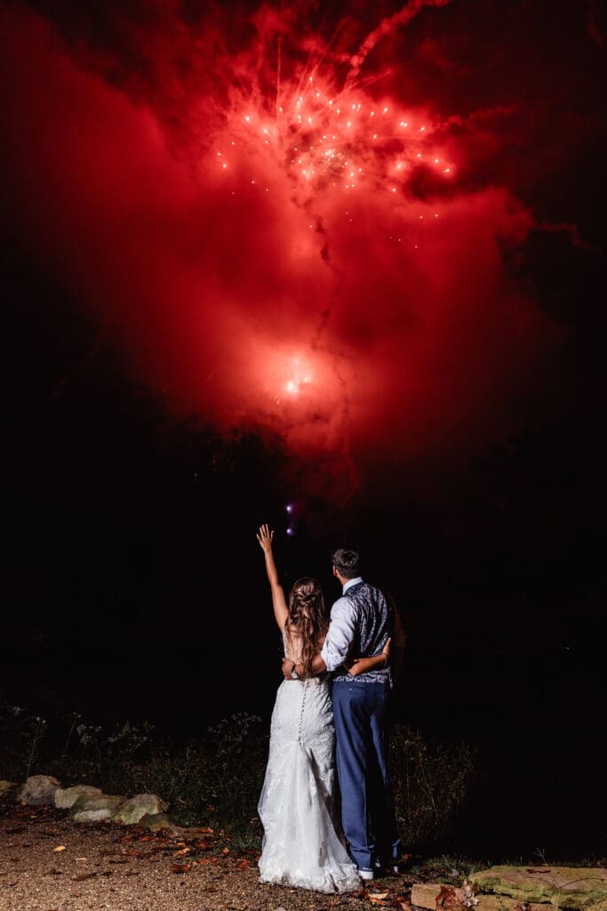 Couple celebrates beneath red fireworks during their Hinckston Run Farm wedding night