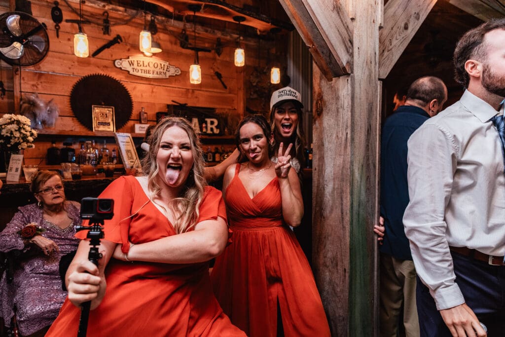 Wedding party dancing and celebrating inside rustic barn venue at Hinckston Run Farm