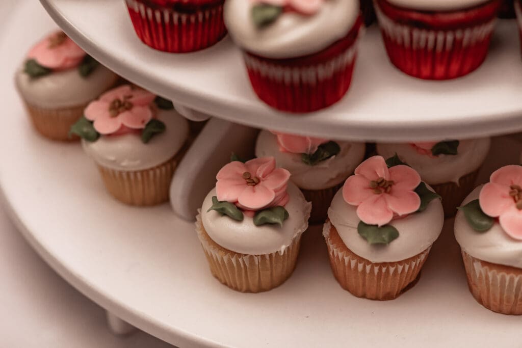 Close-up of cherry blossom design on cupcakes at a Phipps Botanical Gardens wedding reception