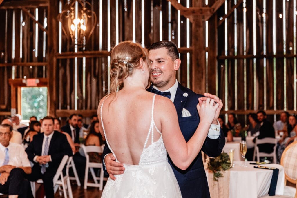 Newlyweds slow dancing together during their wedding reception at The Barn at Ever Thine in Fenelton, PA