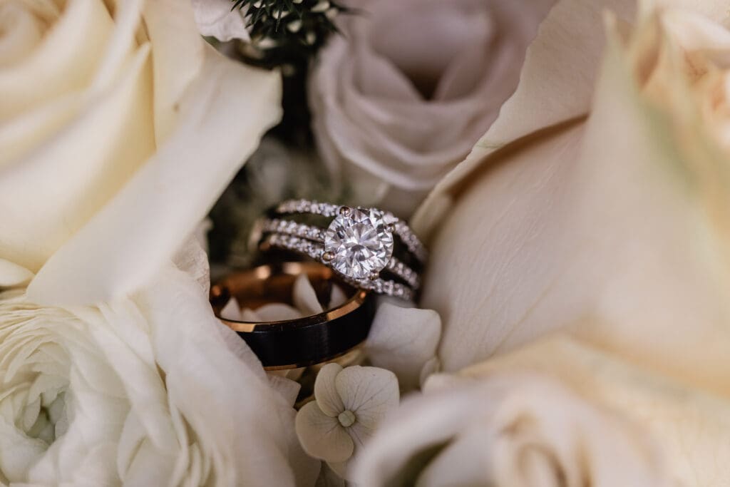 Wedding rings placed inside the bride’s white rose bouquet during a Pittsburgh wedding