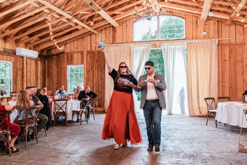 Bridal party cheering and entering reception at Hinckston Run Farm wedding