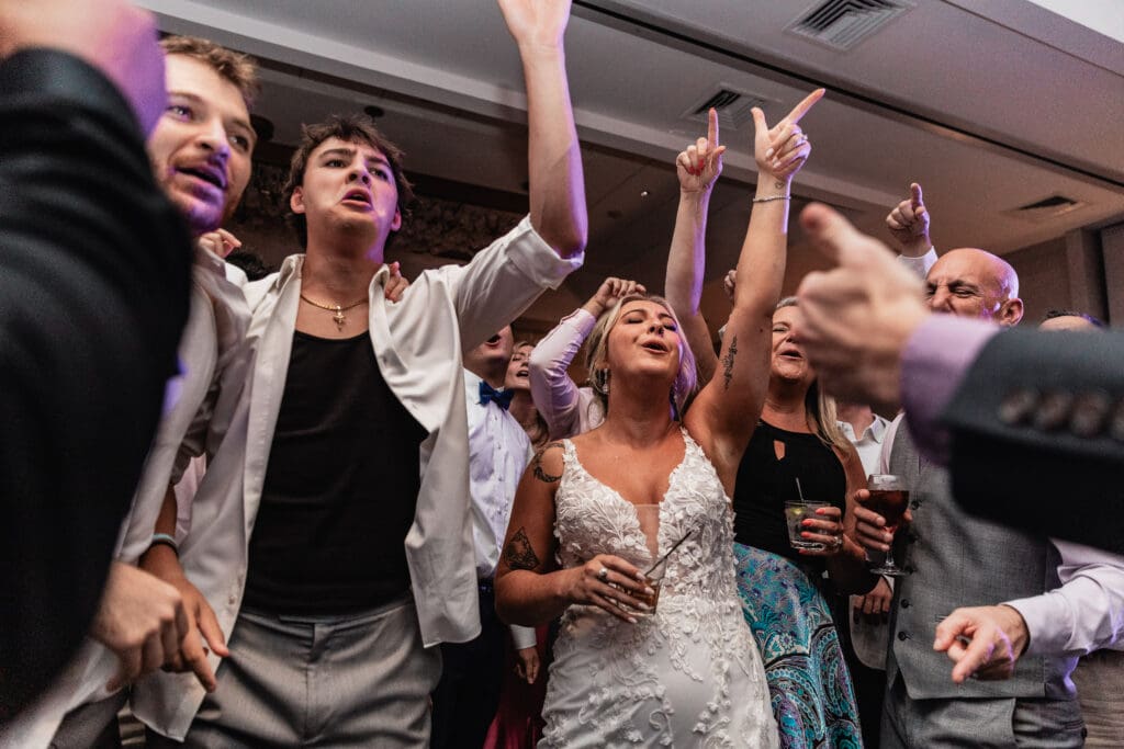 Bride dancing surrounded by friends and family during Pittsburgh Airport Marriott wedding reception