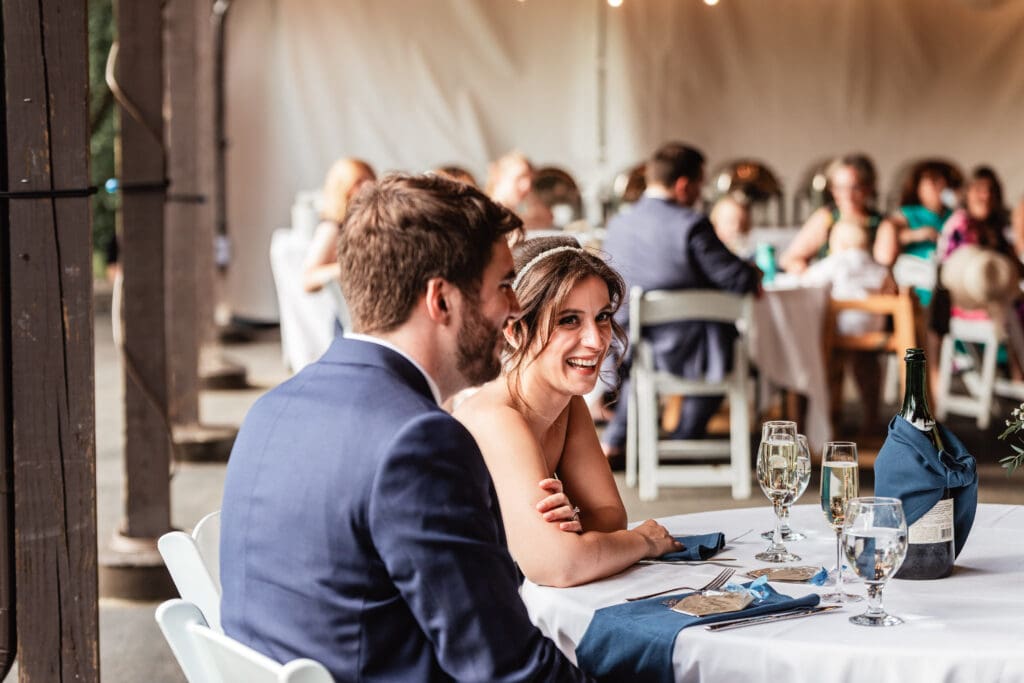 Wedding couple laughing during toasts at Succop Nature Park wedding reception