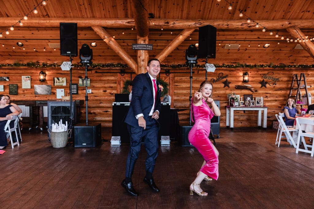 Wedding party striking fun poses during reception entrance at The Gathering Place at Darlington Lake