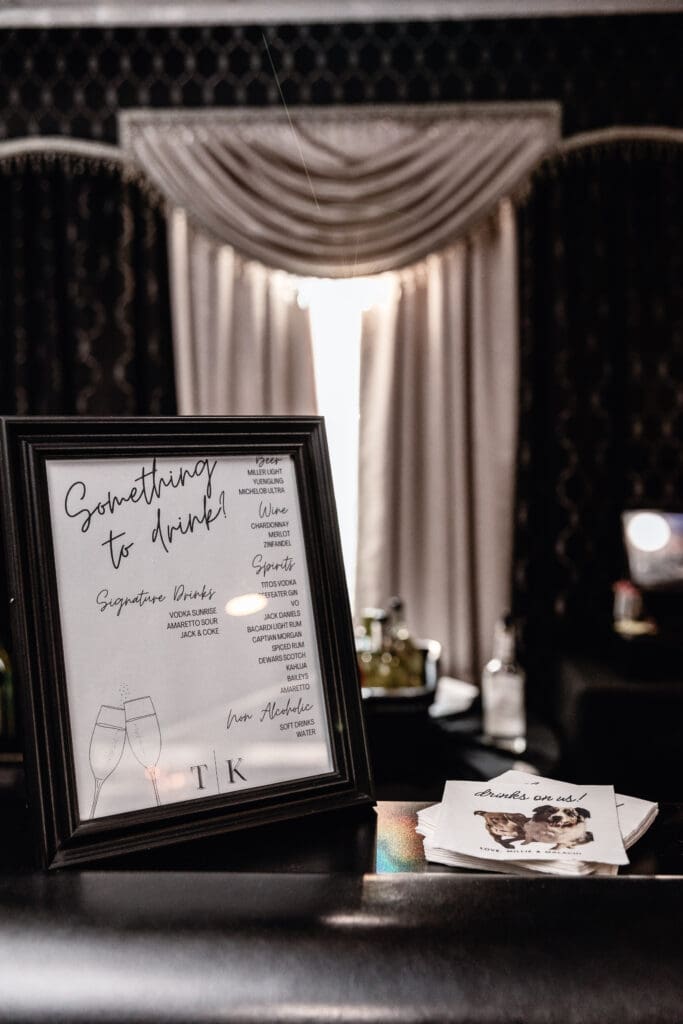 Close-up of signature wedding drinks and custom napkins at a Le Mont reception