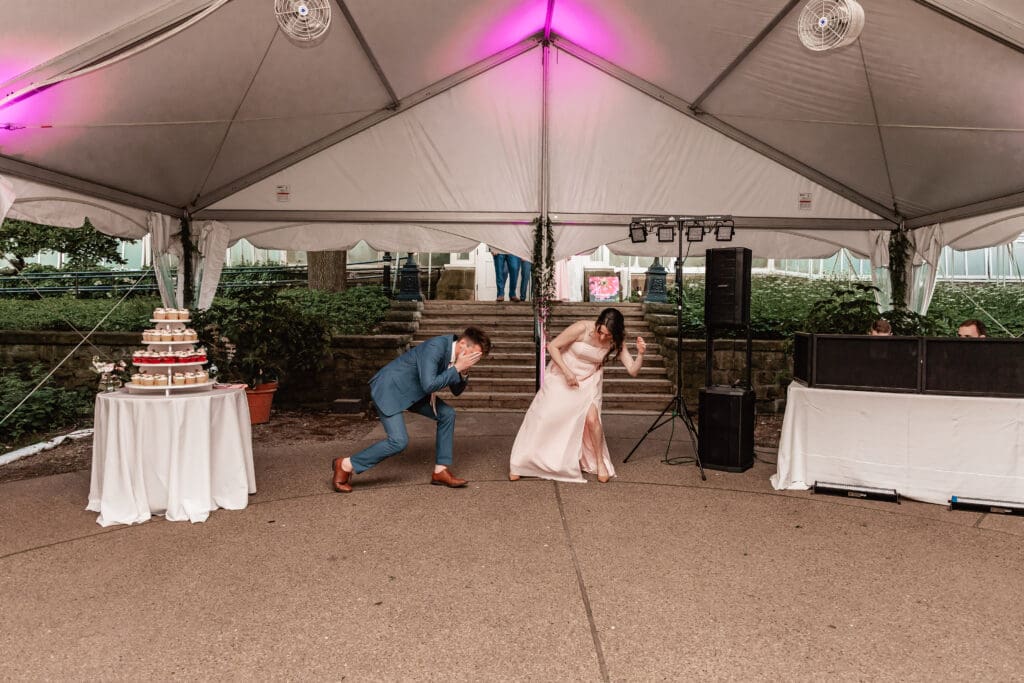 Pittsburgh bridesmaids and groomsmen celebrating and posing during their grand entrance at a Phipps Botanical Gardens wedding