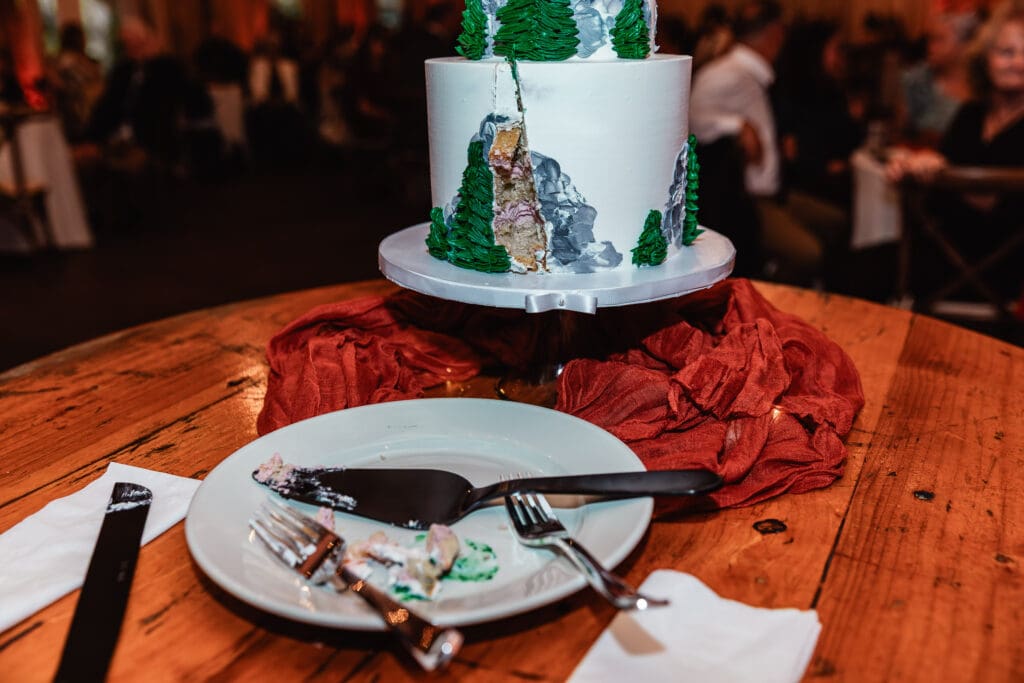 Multi-tiered wedding cake with green and silver accents at Hinckston Run Farm