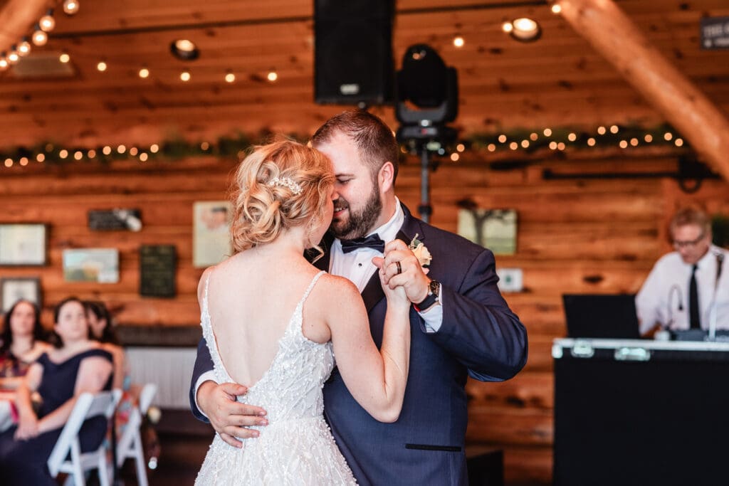 Bride and groom smile during their first dance at The Gathering Place at Darlington Lake reception