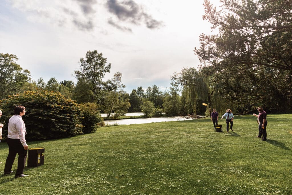 Wedding guests and couple participating in recreational outdoor games at Succop Nature Park reception