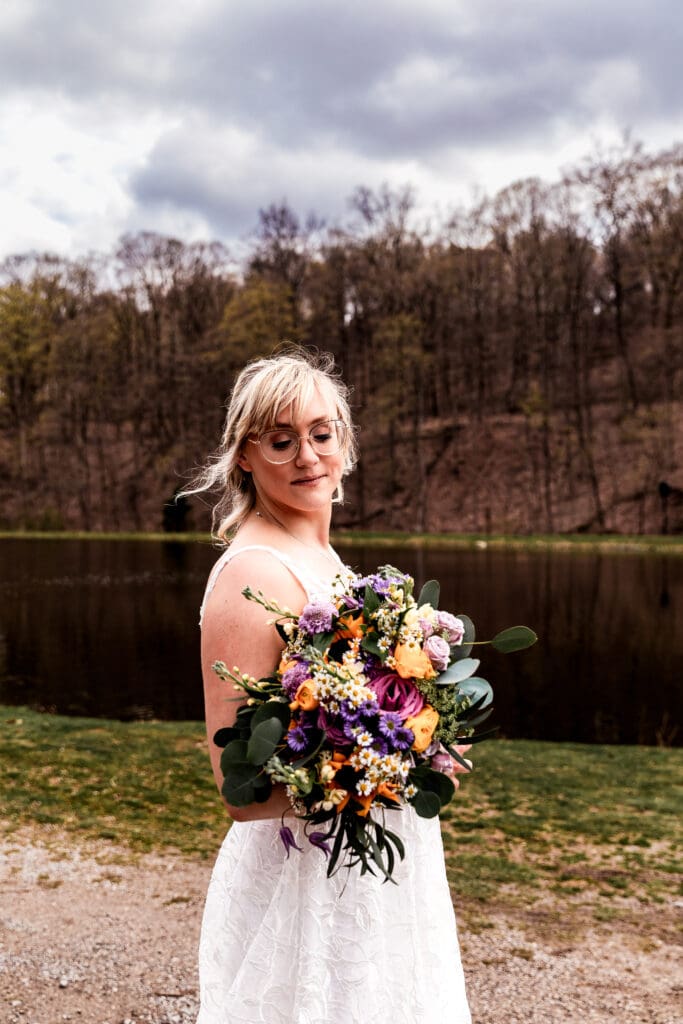 Bride posing with her bouquet at Hopewell Community Park near The Fez during her wedding day