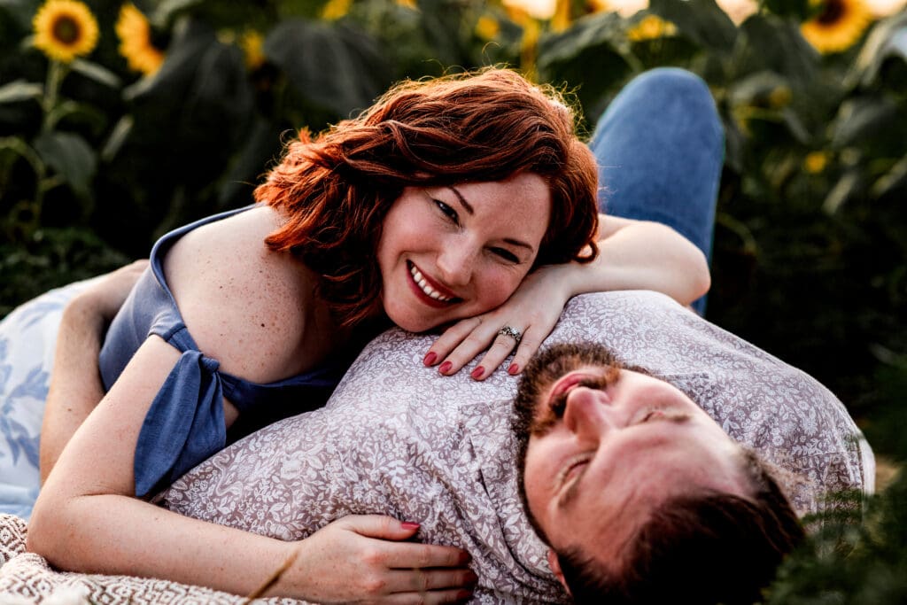 Engagement photo collage of couple lying together on grass during golden hour at Schwirian Sunflower Festival