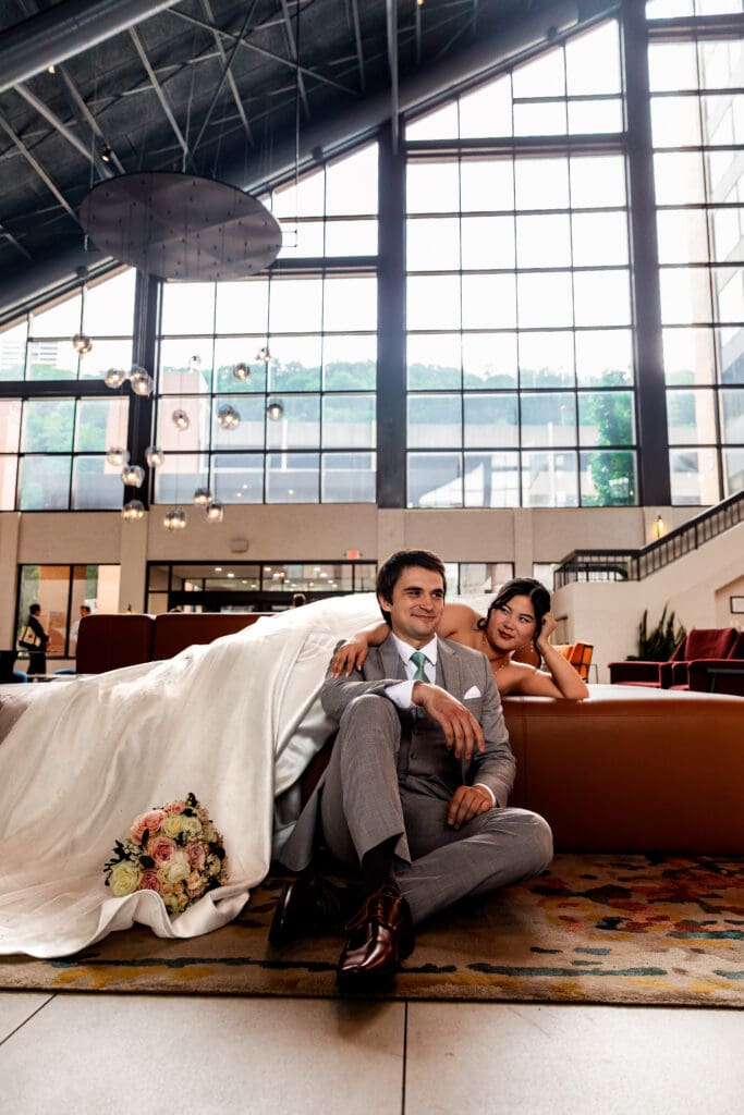Bride and groom pose together in the Sheraton Station Square hotel lobby