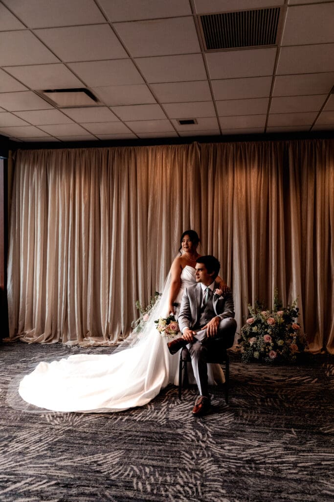 Wedding couple sits together in a formal portrait inside Sheraton Station Square