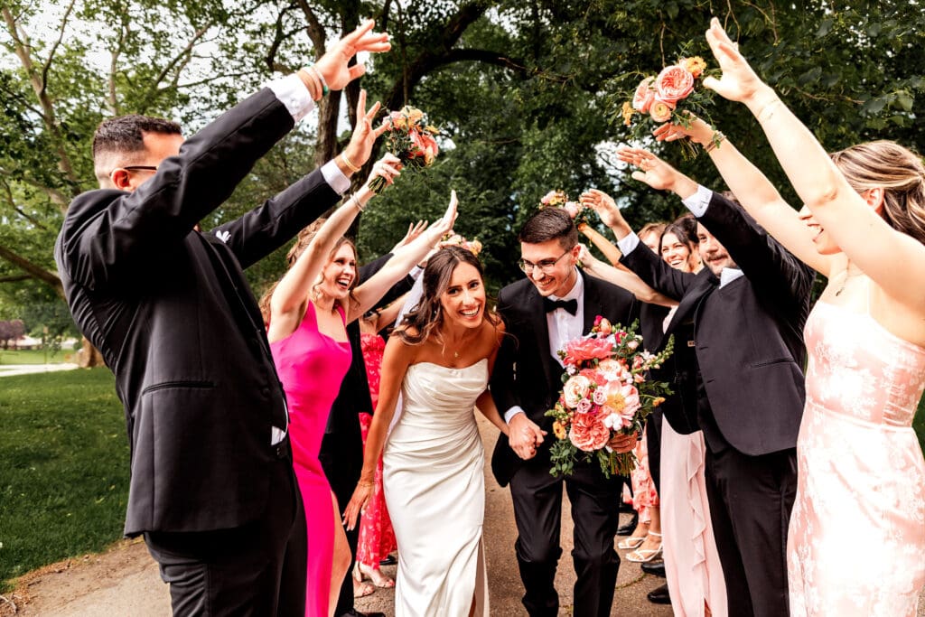 Wedding party forming tunnel of love as couple runs through at National Aviary wedding
